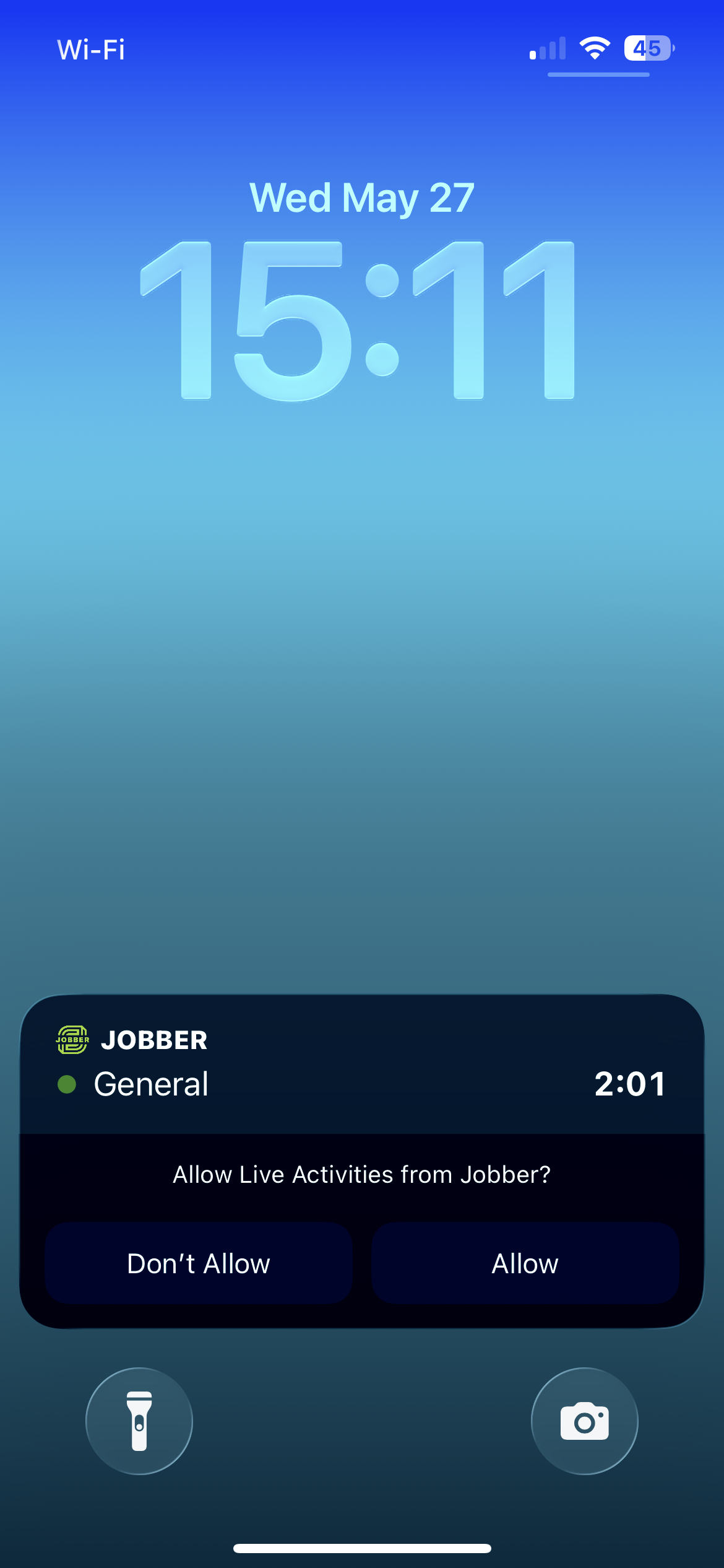 A screenshot showing a live activities box on the lock screen in iOS, including the request to allow it to appear. 